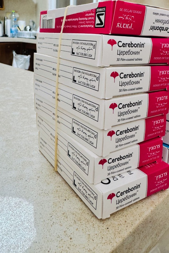 Stack of identical Cerebonin medication boxes held together with a rubber band